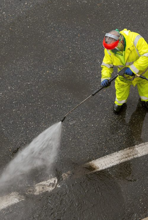 Worker cleaning a city road